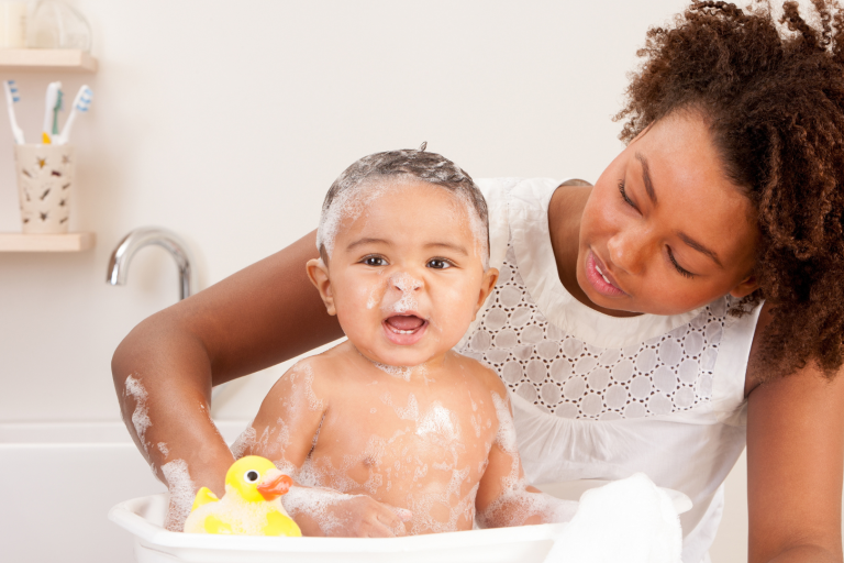 Mum bathing baby