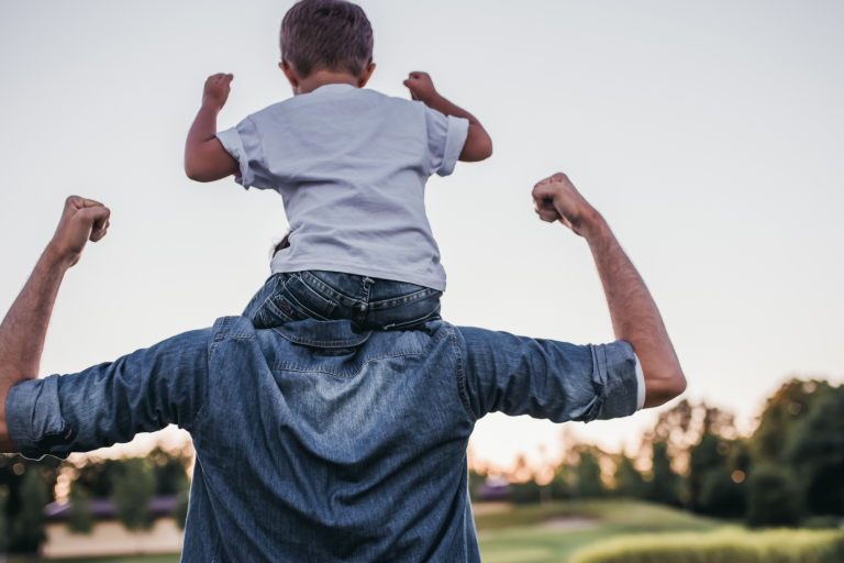 Dad with young boy on shoulders