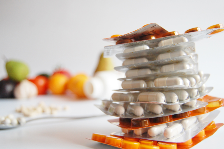 Stack of medication pill packets on table