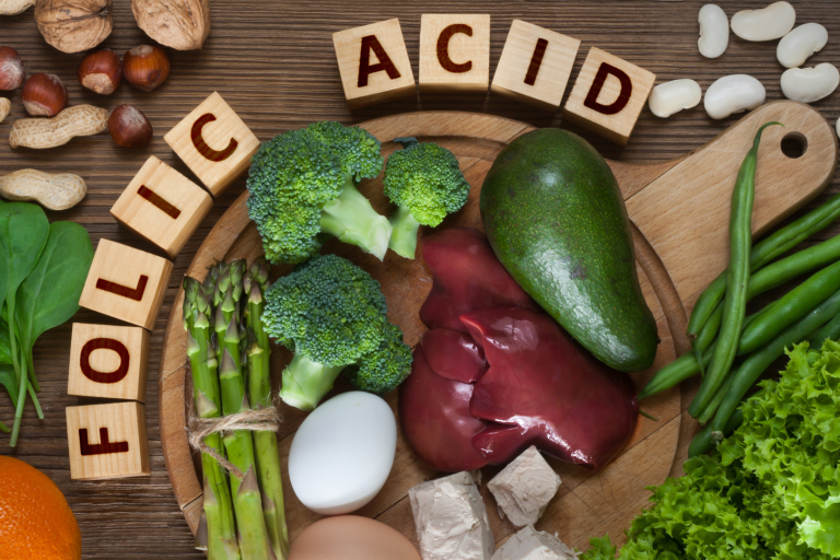 Vegetables and nuts with letters spelling folic acid