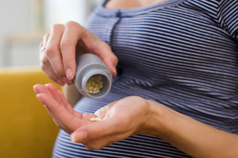 Pregnant lady taking vitamins