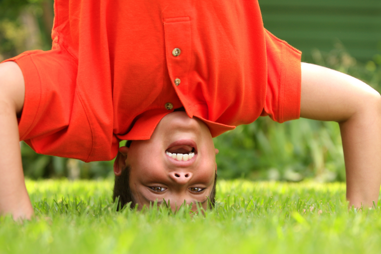 Primary school boy doing a head stand