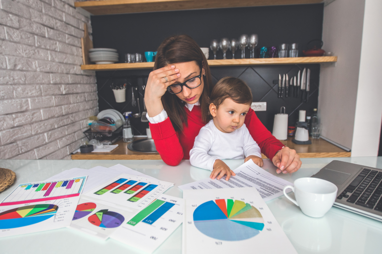 mum with baby on knee at desk