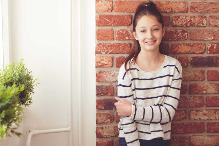 Teenage girl holding arm