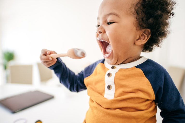 Toddler using spoon