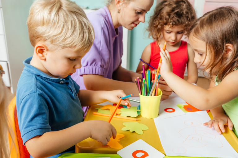 Toddlers at table doing crafts