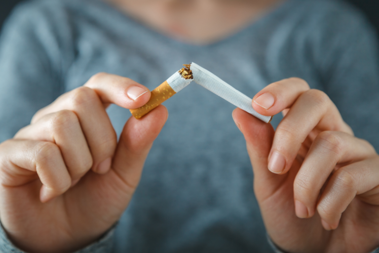 women breaking cigarette