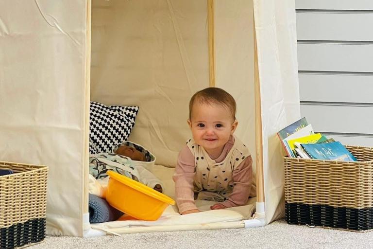 Baby sat in a tent