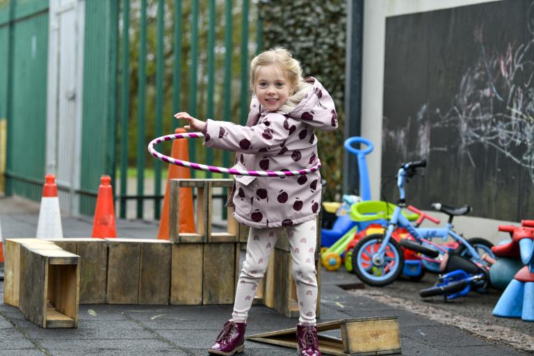 Child playing with a hoop