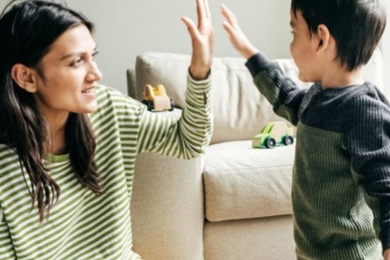 Mother and child high fiving each other