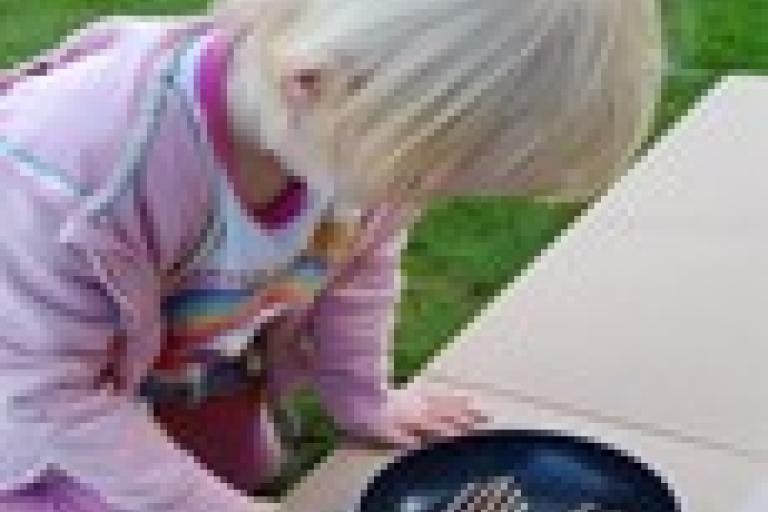 Child pretending to fry sausages