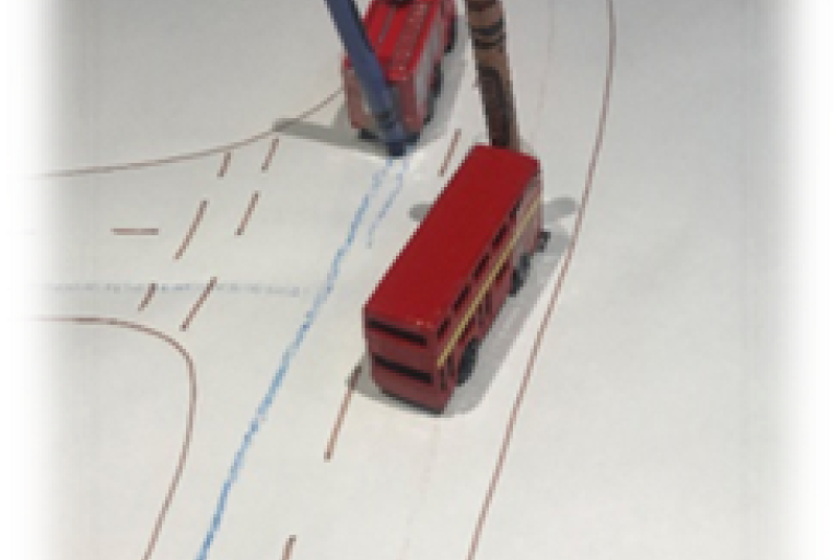 Crayons taped to toy vehicles to create patterns