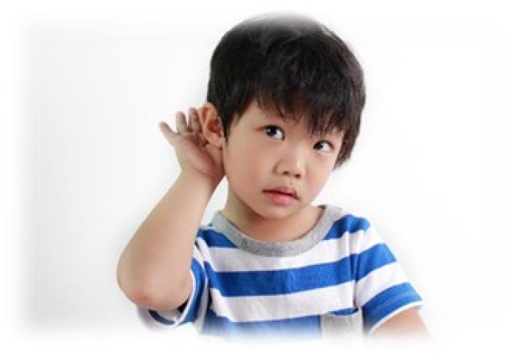 Child holding their hand up to the ear