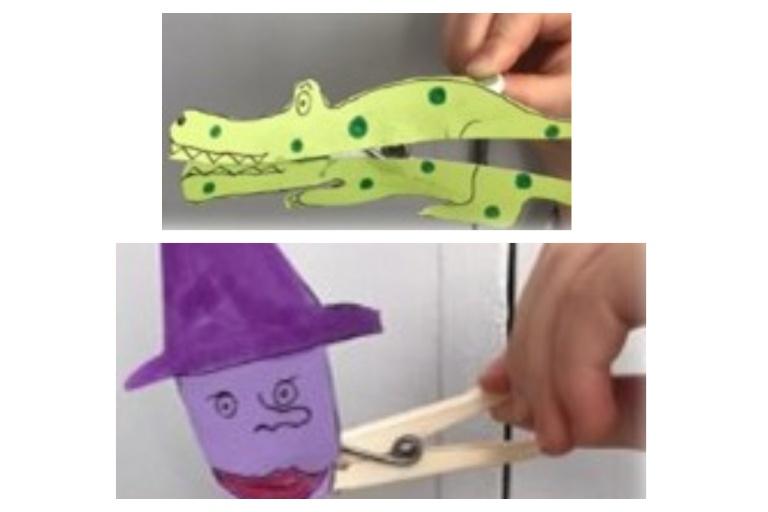 Coloured pieces of paper, decorated as faces on pegs