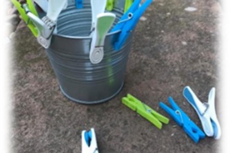 Pegs clipped on the edge of a tin