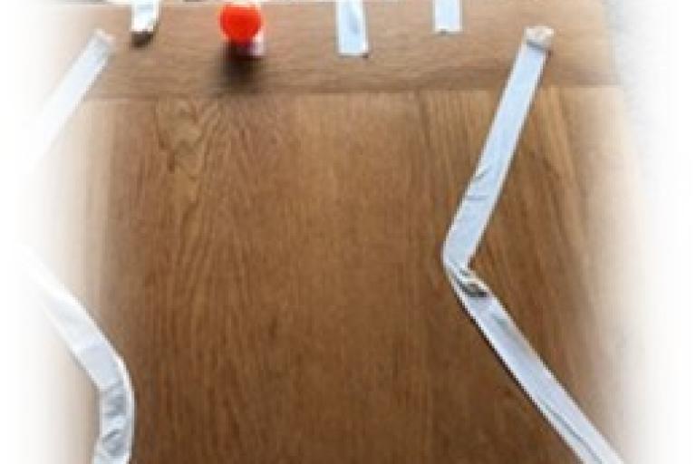 Paper cups taped onto a table