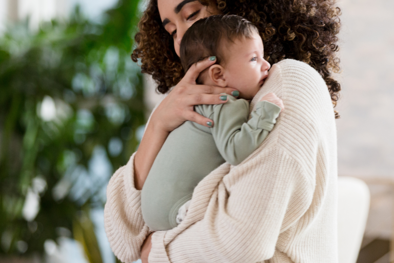 Baby being held by mother to soothe