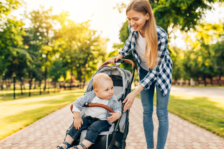 Adult outside with child in a pushchair