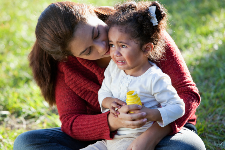 Toddler sat on mothers lap upset