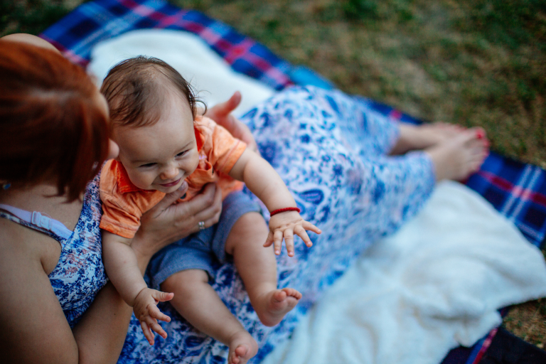 Adult and child sat outside