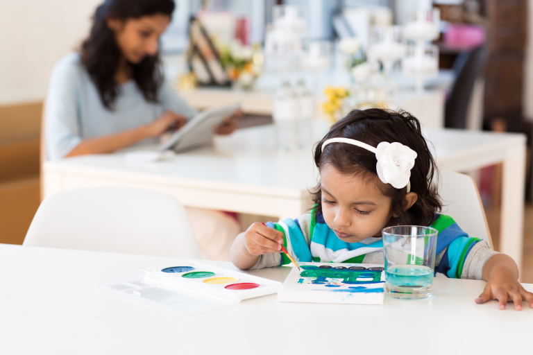 Child sat at a table painting