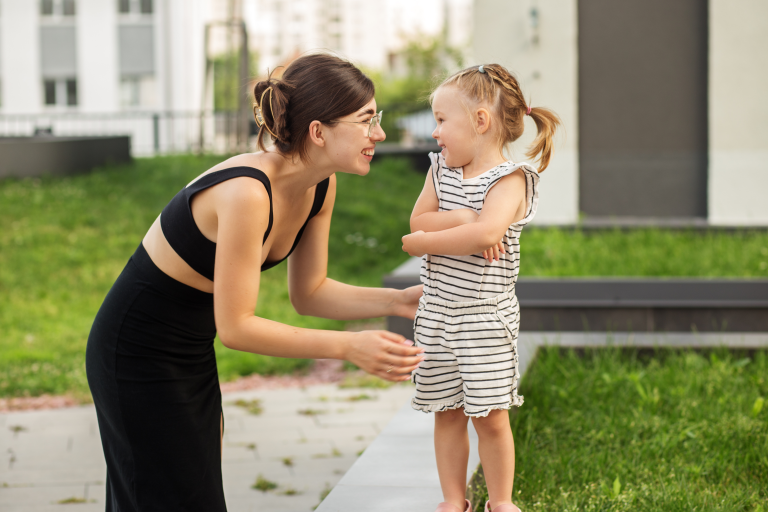 Adult and child outside talking