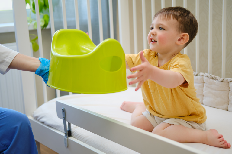 Child being handed a potty