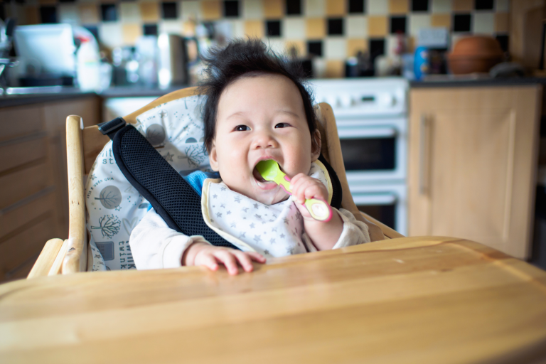 Child sat on a high chair