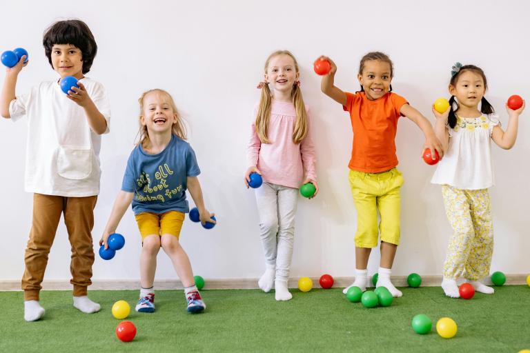 Children playing ball games indoors