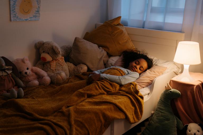 Young child sleeping on the bed