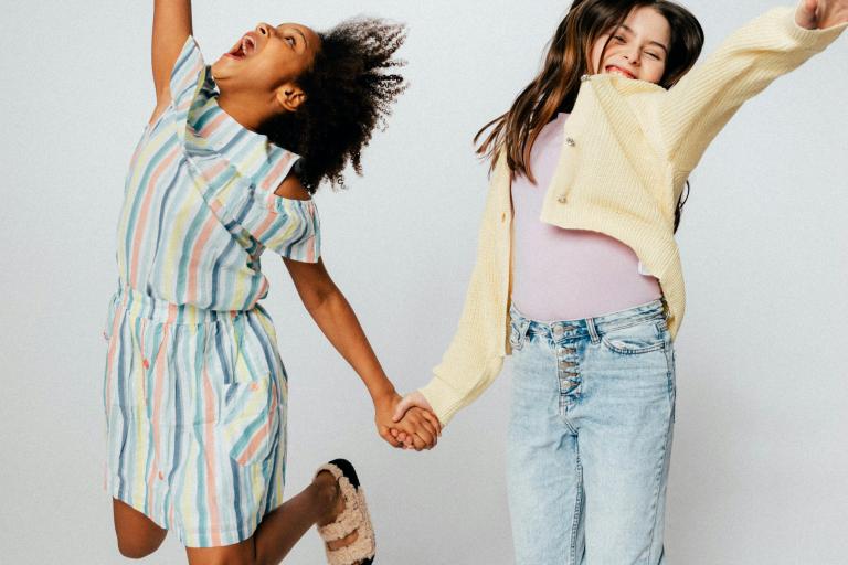 Two children jumping up