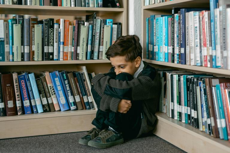 Child sitting alone in the library
