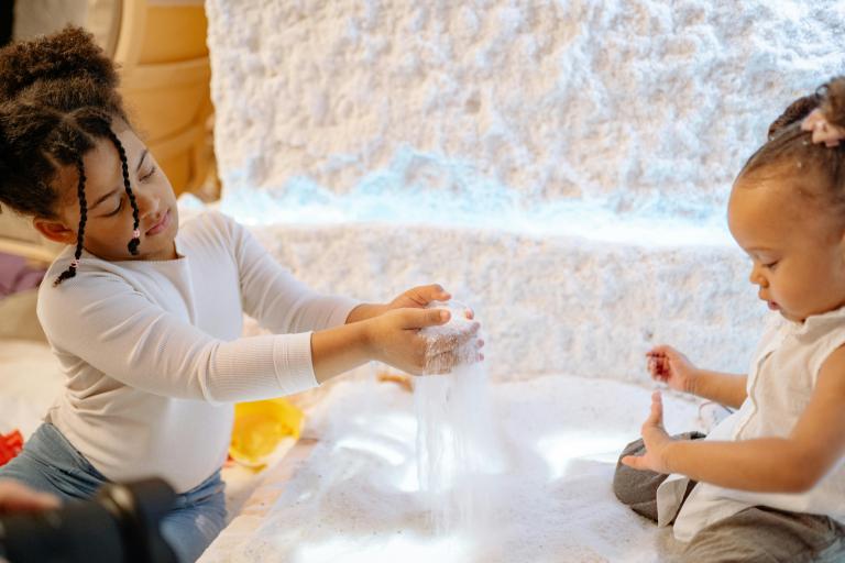 Two children playing with sand