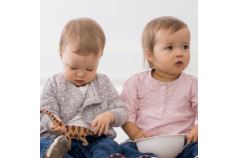 Two children sat on the floor