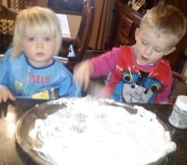 Two children playing in flour