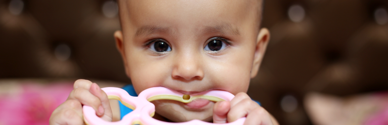 baby with teething ring