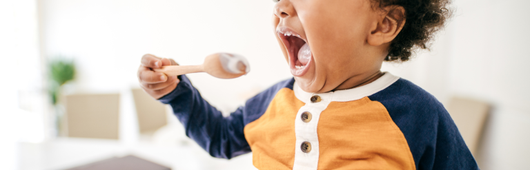 Toddler using spoon