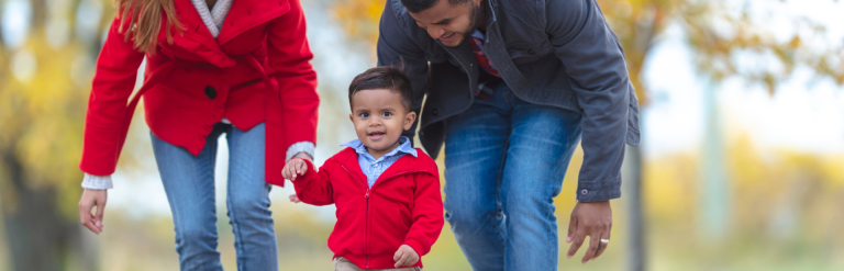 Parent walking in park with toddler