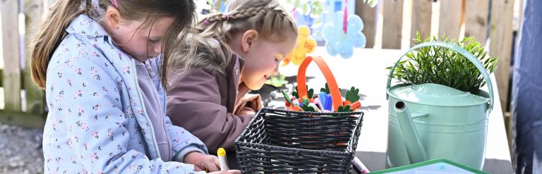 Two children outside drawing