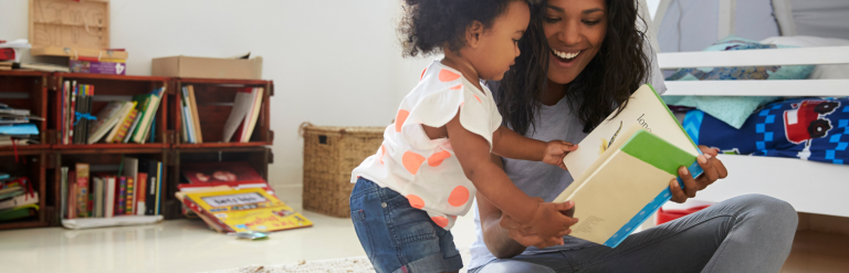Adult and child looking at a book