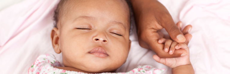 Child sleeping whilst holding adults hand
