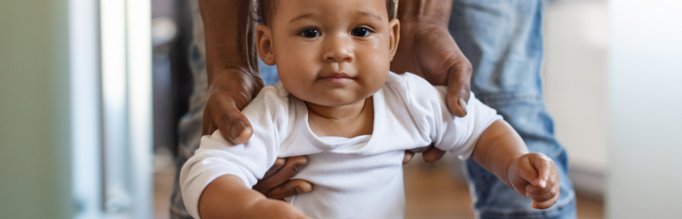 Child being held father whilst standing