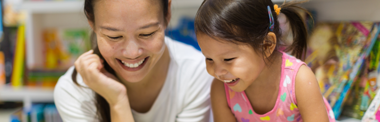 Adult and child reading a book