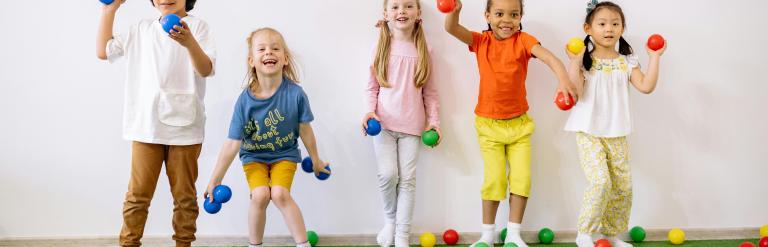 Children playing ball games indoors
