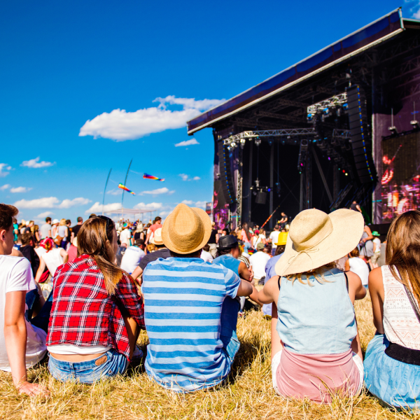 Festival goers sitting on grass