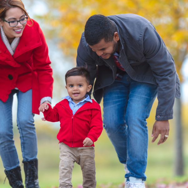 Parent walking in park with toddler