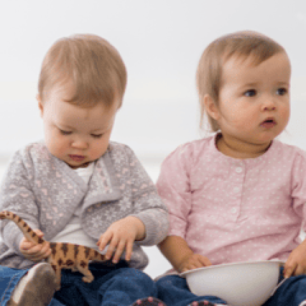 Two children sat on the floor